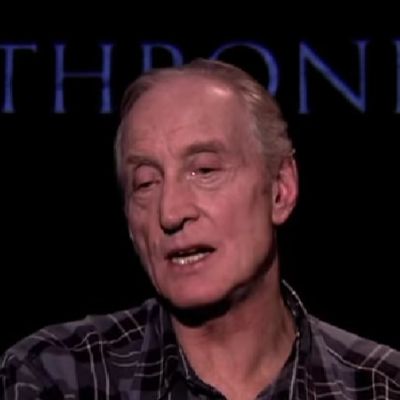 Charles Dance is speaking while there is Game of Thrones logo in the background.